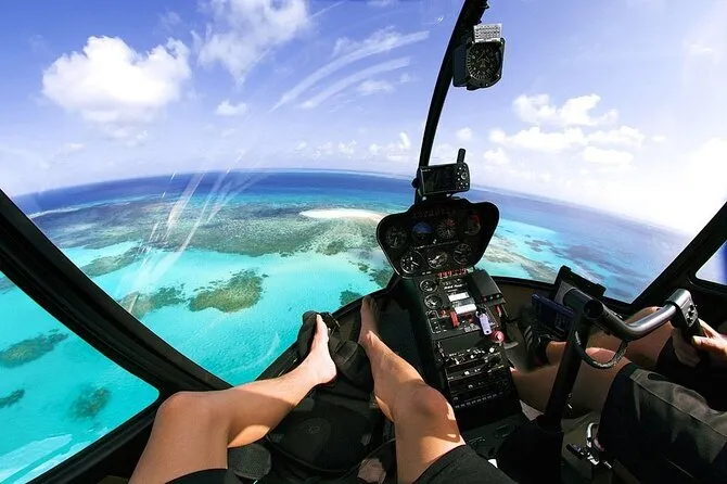 Aerial view of White Beach and turquoise reef flats from a helicopter tour in a Boracay tours package, Philippines